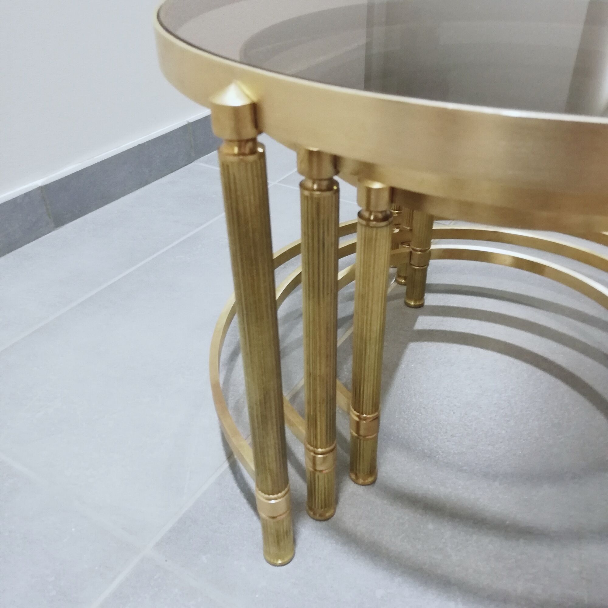 Trois tables gigognes laiton doré et verre fumé