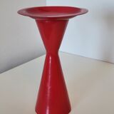 Vintage design candlestick in red metal in the shape of an hourglass