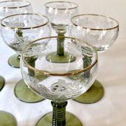 7 Alsace Roemer wine glasses, moss green stepped bases and gold trim.
