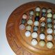 Ancient solitaire game in wood and stone marbles
