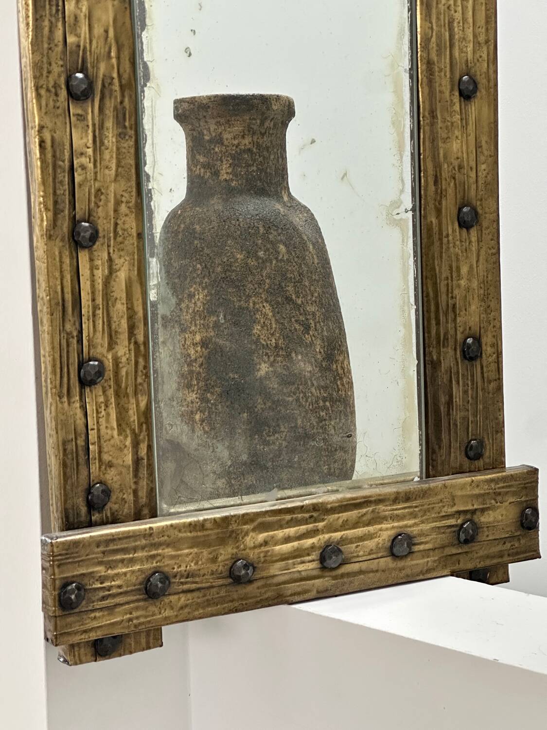 Brutalist mirror with a hammered copper and brass frame.