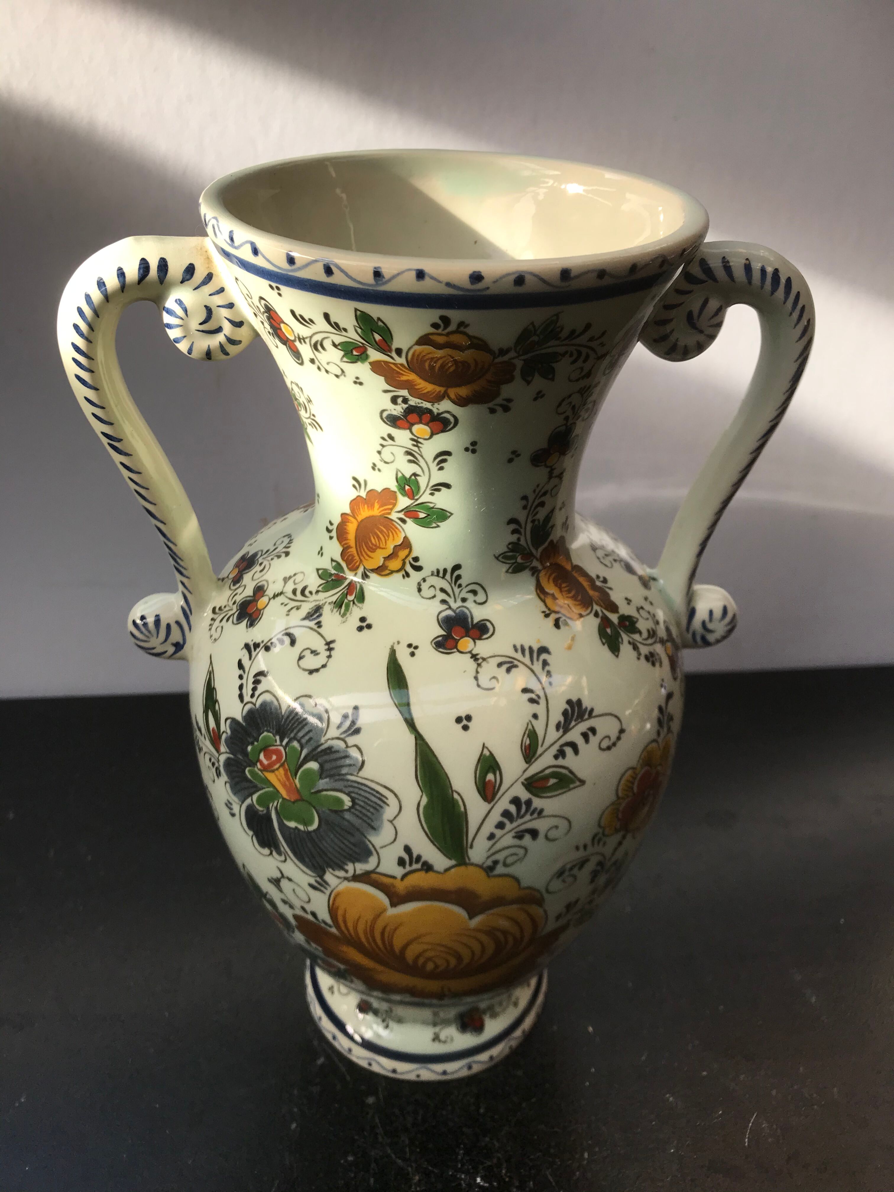 Ancient Delft vase with white ceramics decor vintage flowers