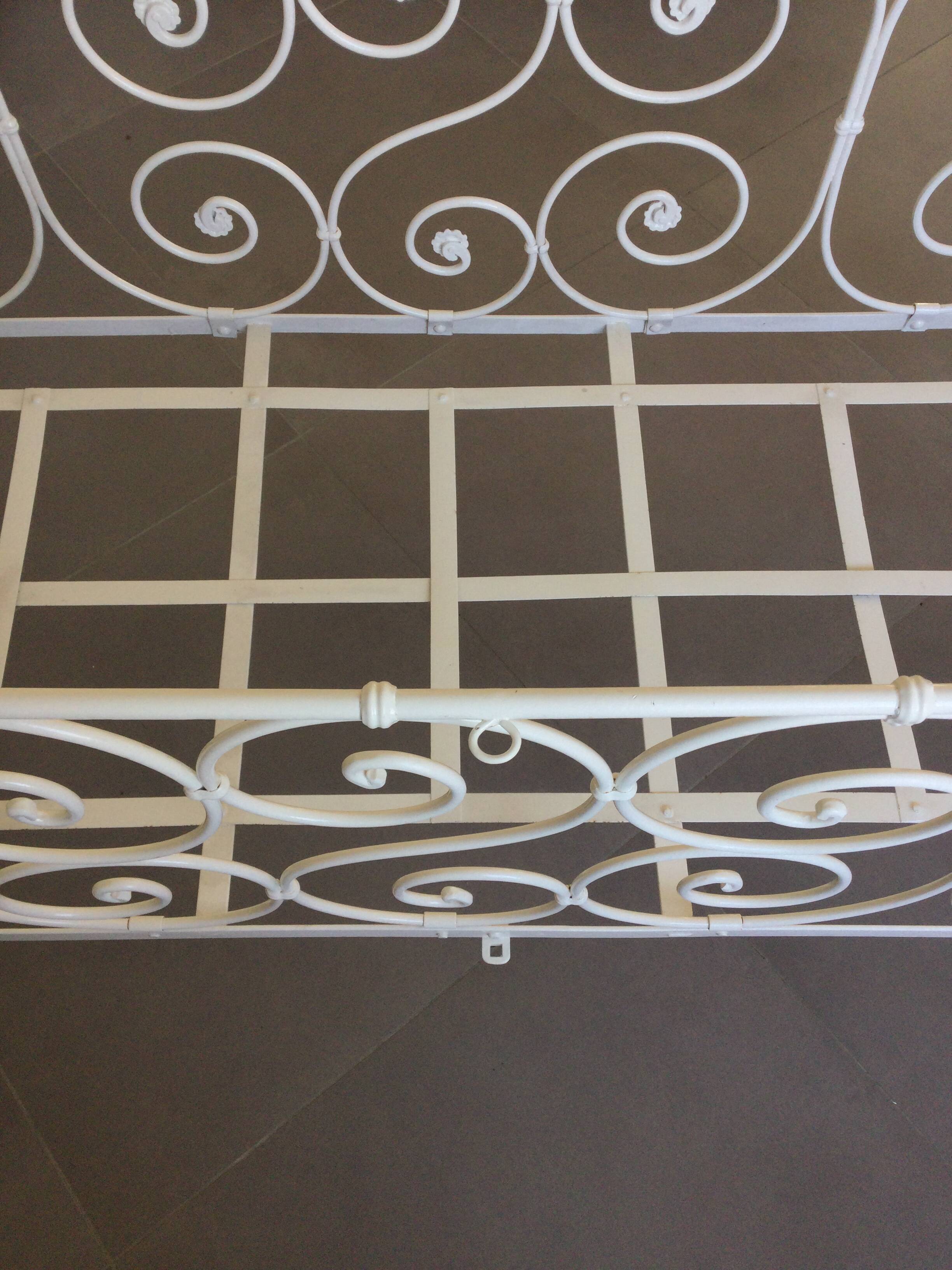 White wrought iron folding bed