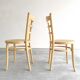 Paire chaises Baumann bois clair et cannage