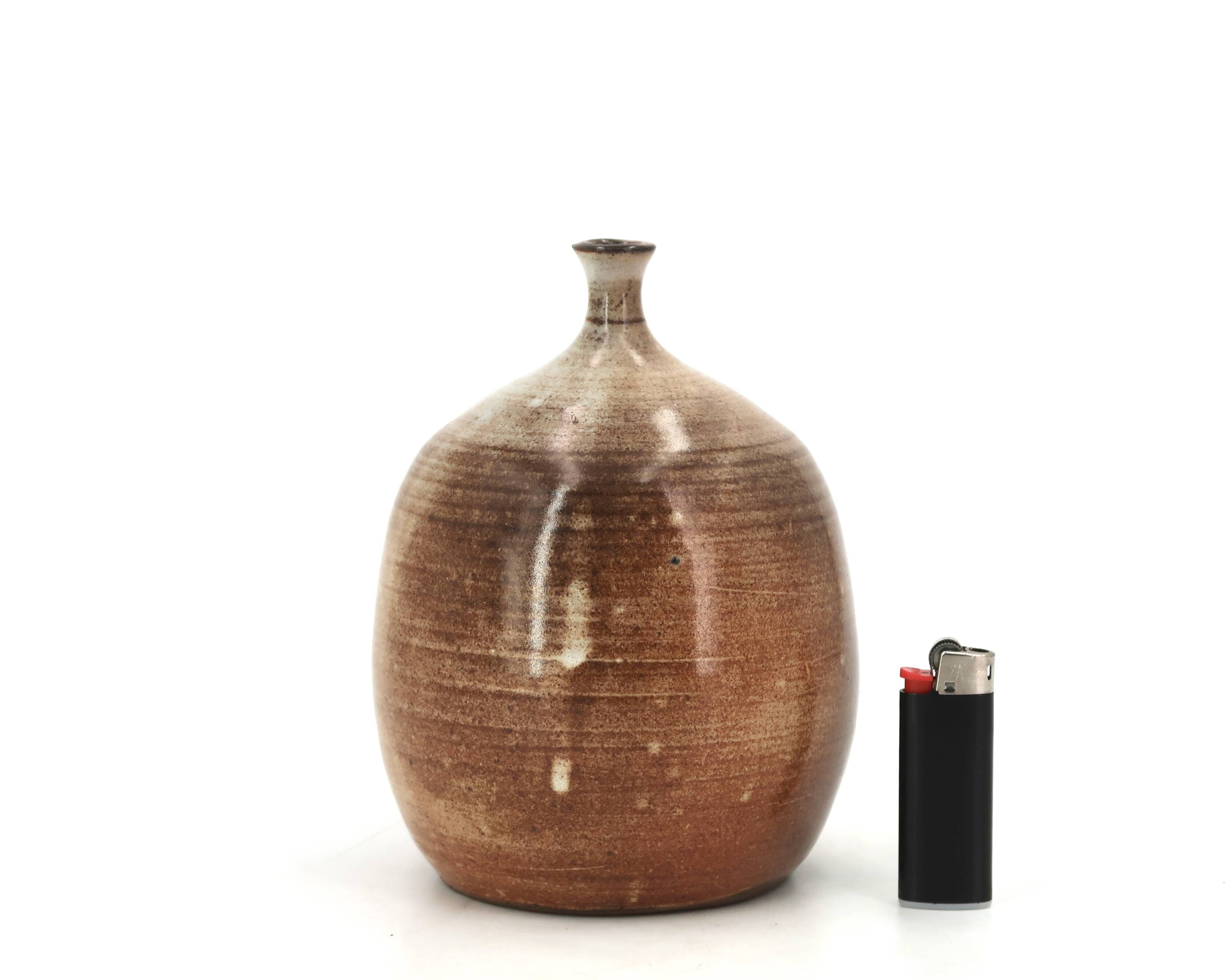 Ovoid vase with a small neck in brown beige ceramic and white drips.
