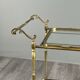 Rolling table cart in gilded brass with two glass shelves, 20th century.
