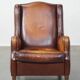 Vintage sheepskin leather armchair finished with black piping