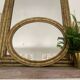 Miroir en bois doré patiné 58cm