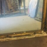 Old mirror with gilded leaves and flowers carved on top of it 1800s