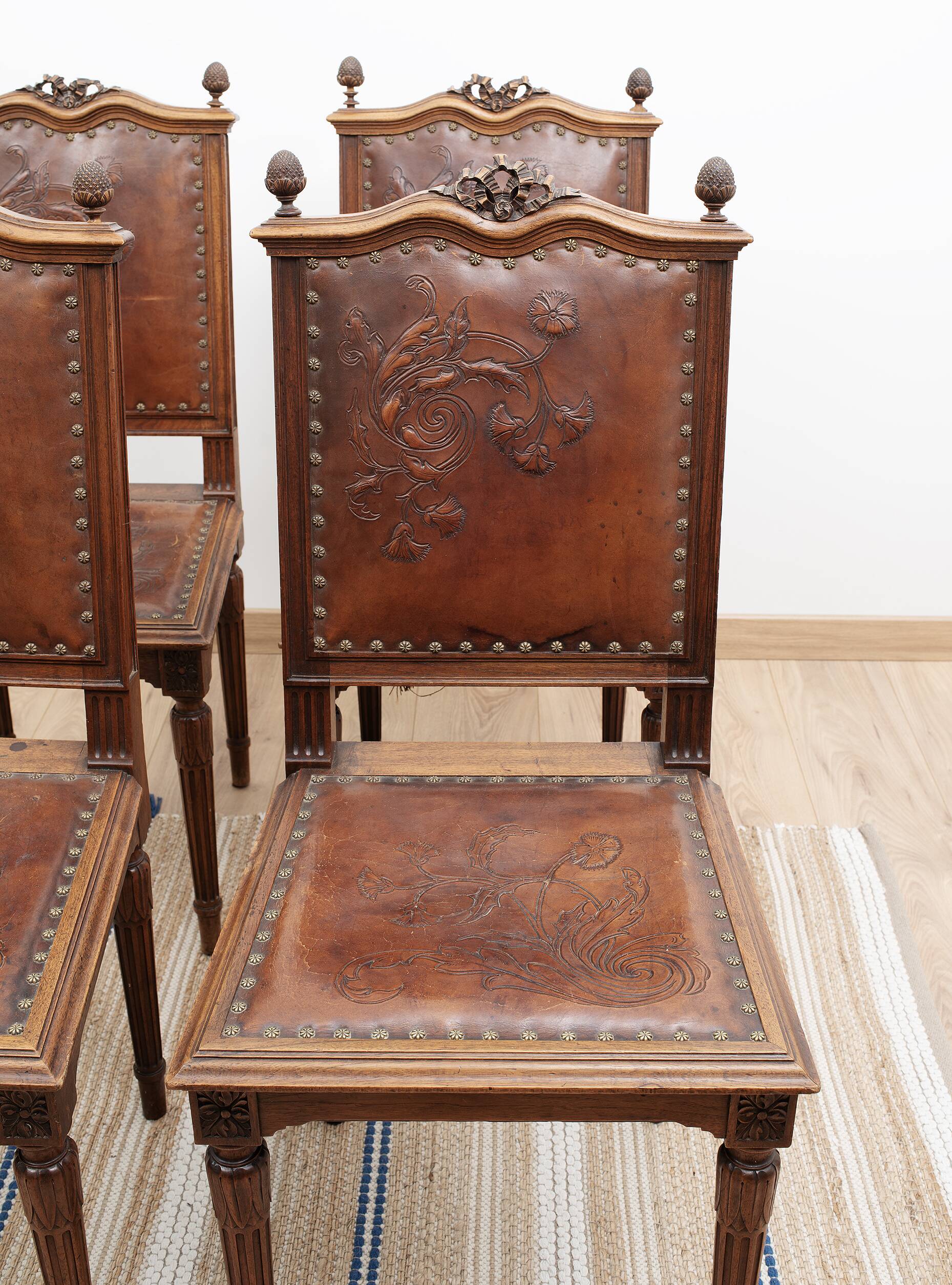 Set of 4 Louis XVI style chairs in carved wood and embossed leather.