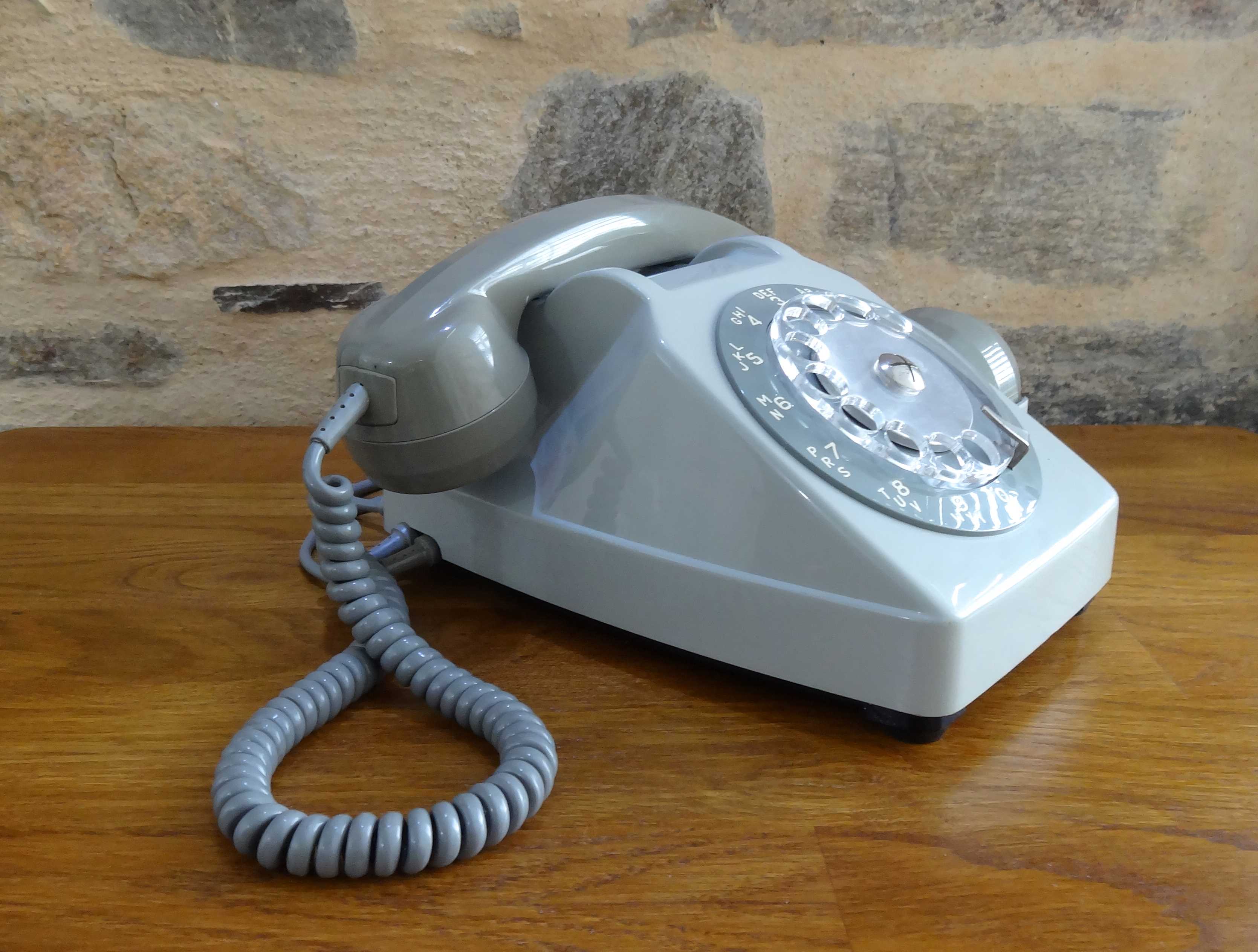 Grey vintage rotary dial phone with earpiece