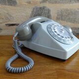 Grey vintage rotary dial phone with earpiece
