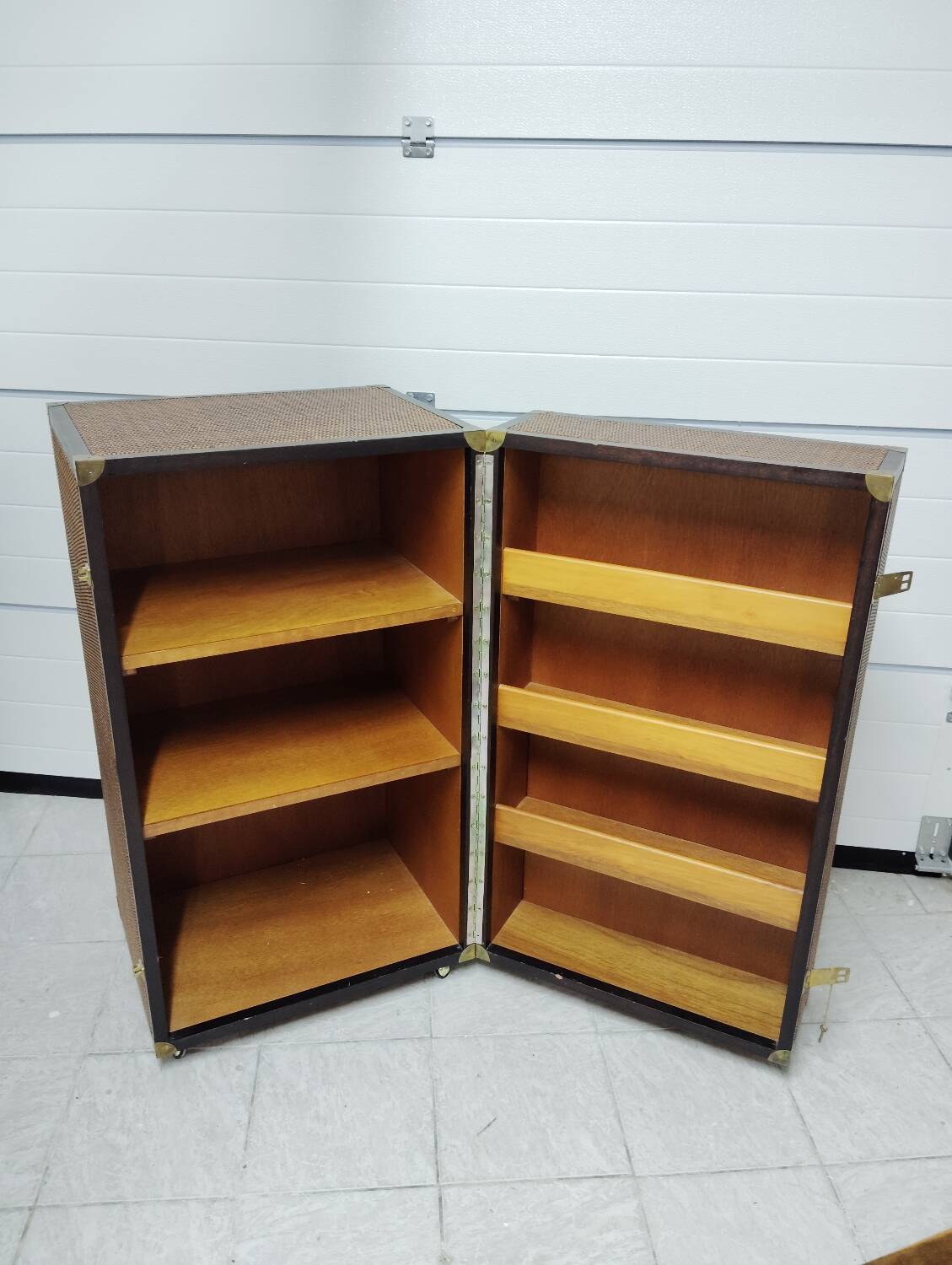 Wardrobe trunk on casters in mahogany and woven rattan.