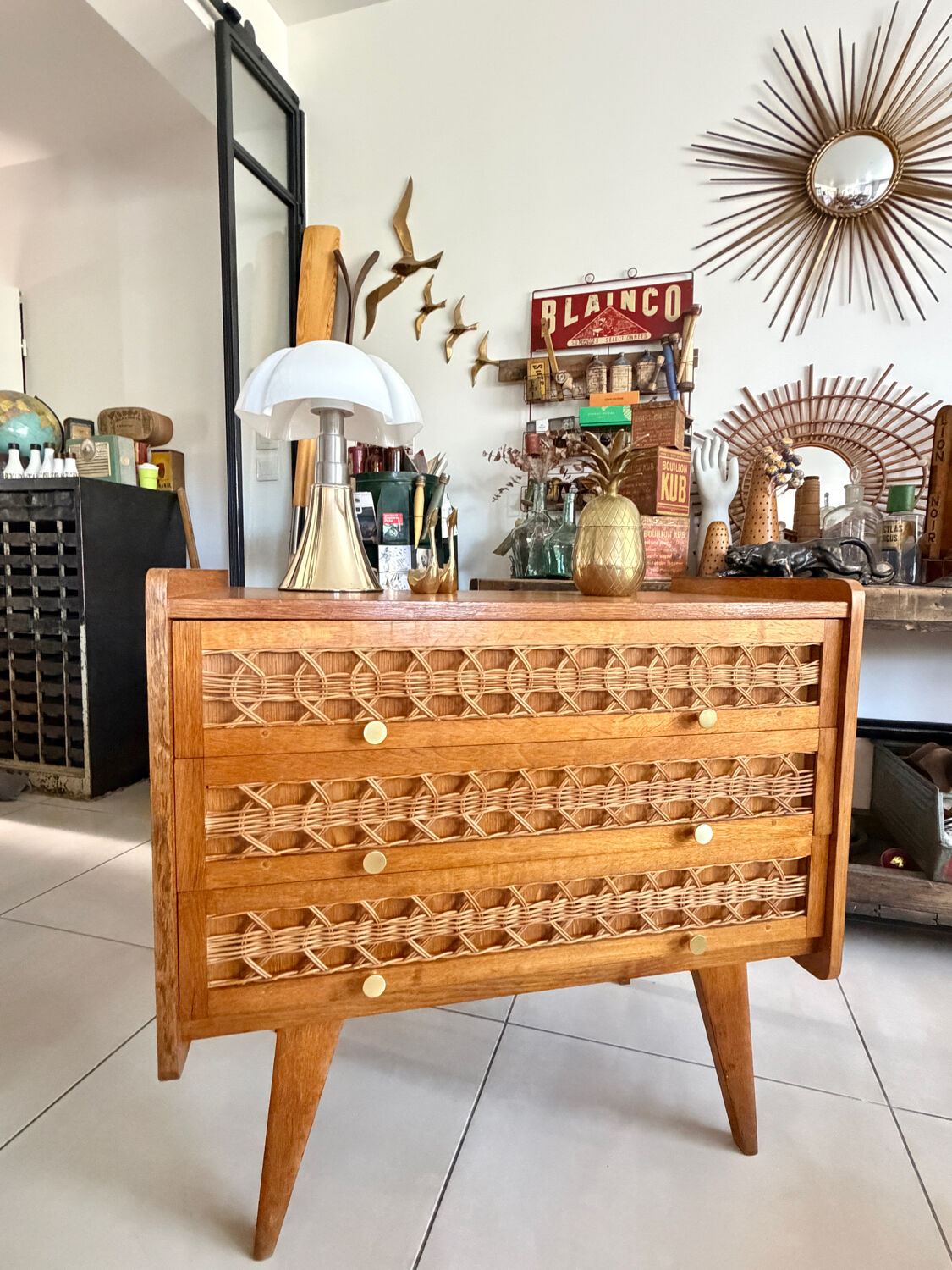 Vintage wooden and rattan chest of drawers with tapered legs.