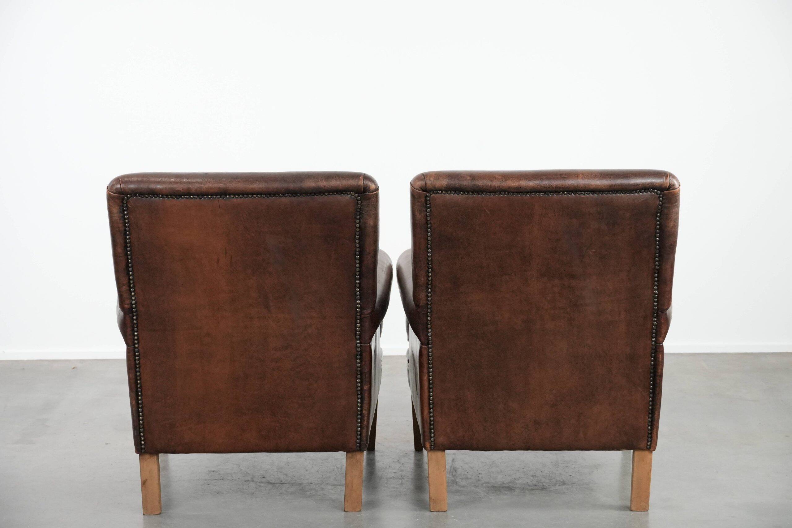 Set of two characterful sheepskin armchairs with a beautiful deep colour