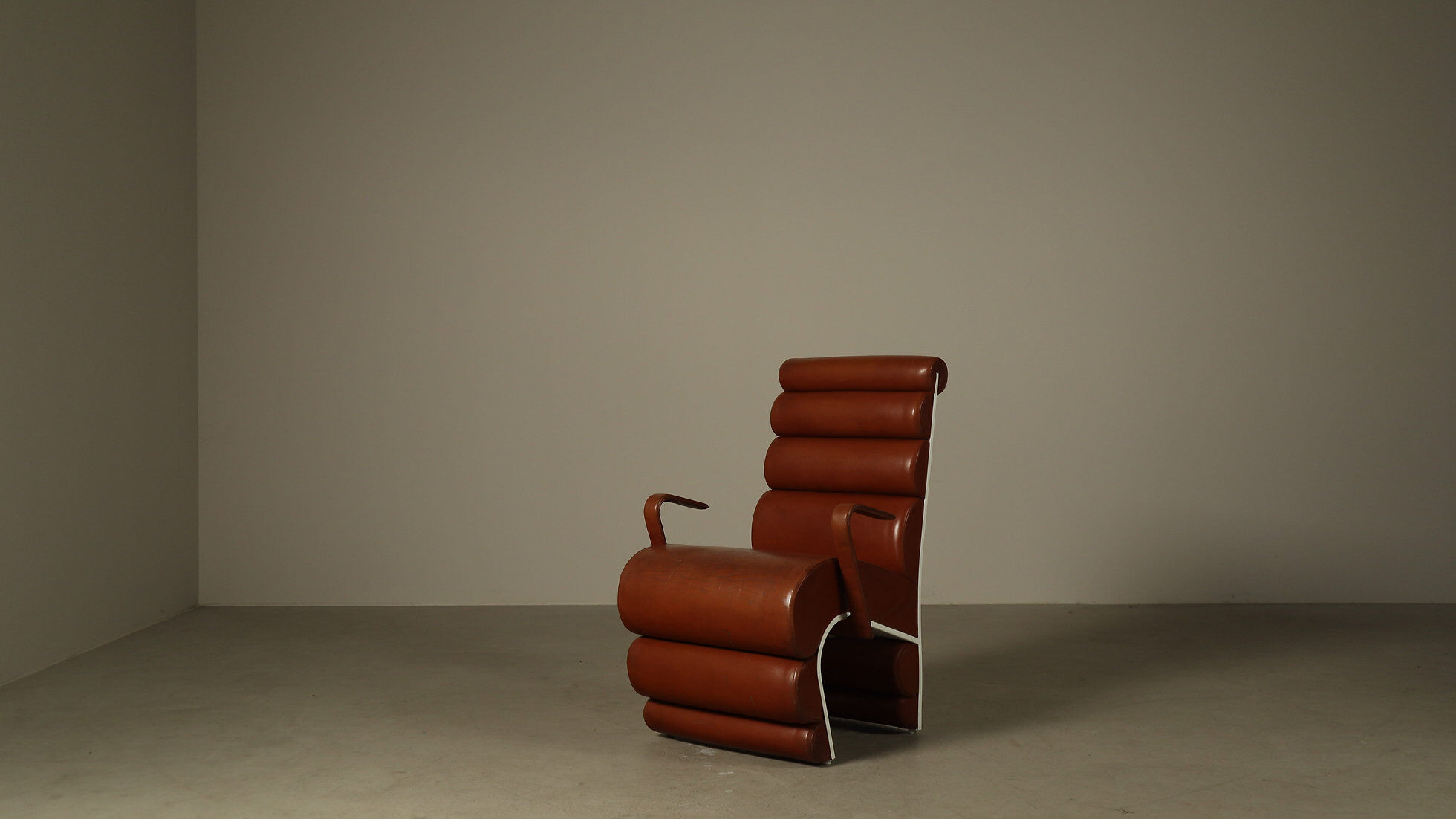 Pair of sculptural cognac leather armchairs, 1970s