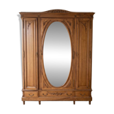 Antique solid wood wardrobe with an oval mirror.