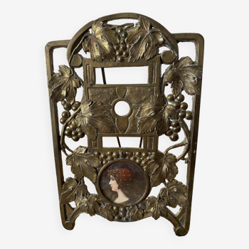 Bronze photo holder to stand with “Woman bust” medallion and vine decoration.