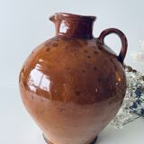 Old pitcher in glazed terracotta
