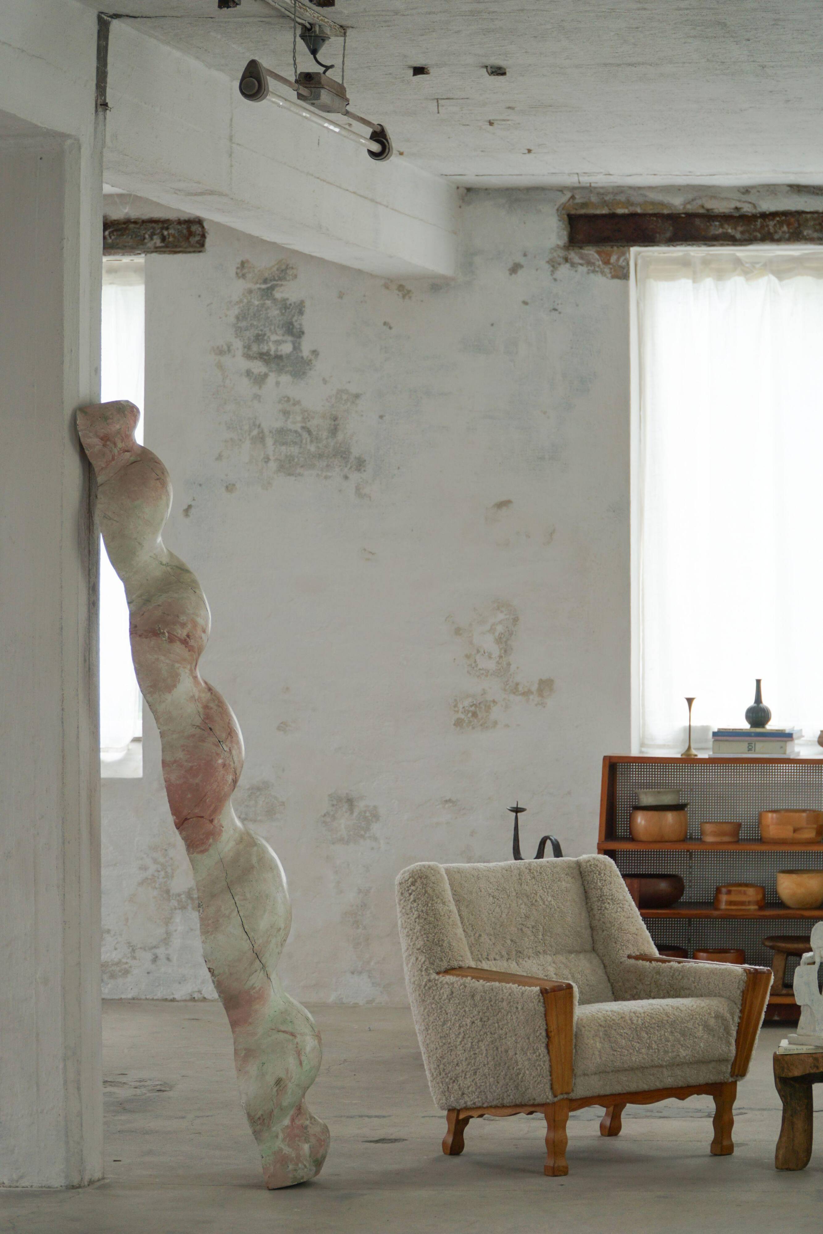 Modern Danish, a pair of easy chairs in oak and lamb's wool, Henning Kjærnulf, 1960s.