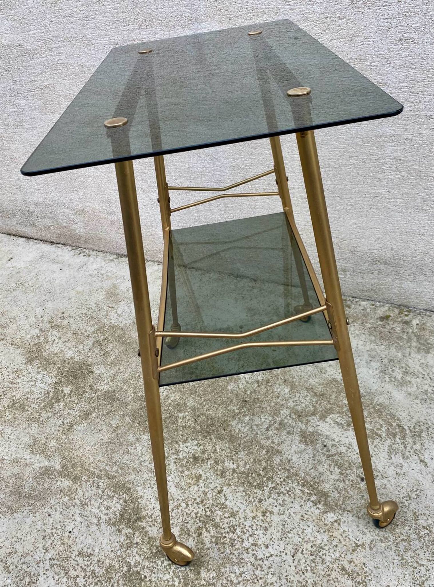 Vintage 1970s glass and gold rolling console table.