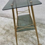 Vintage 1970s glass and gold rolling console table.