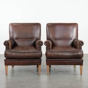 Set of two characterful sheepskin armchairs with a beautiful deep colour