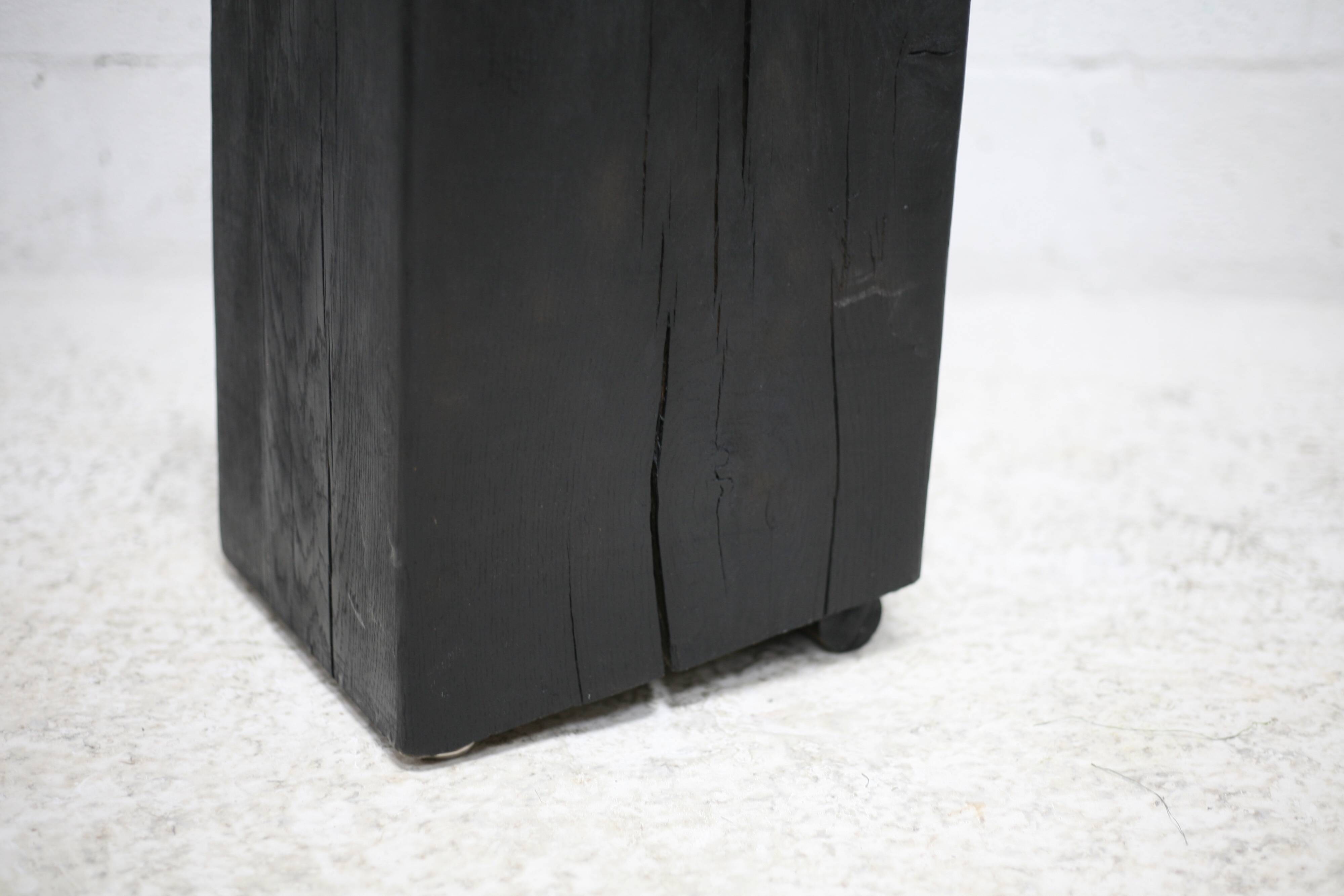 Brutalist chair, black-stained raw wood, steel. Work from the 1970s