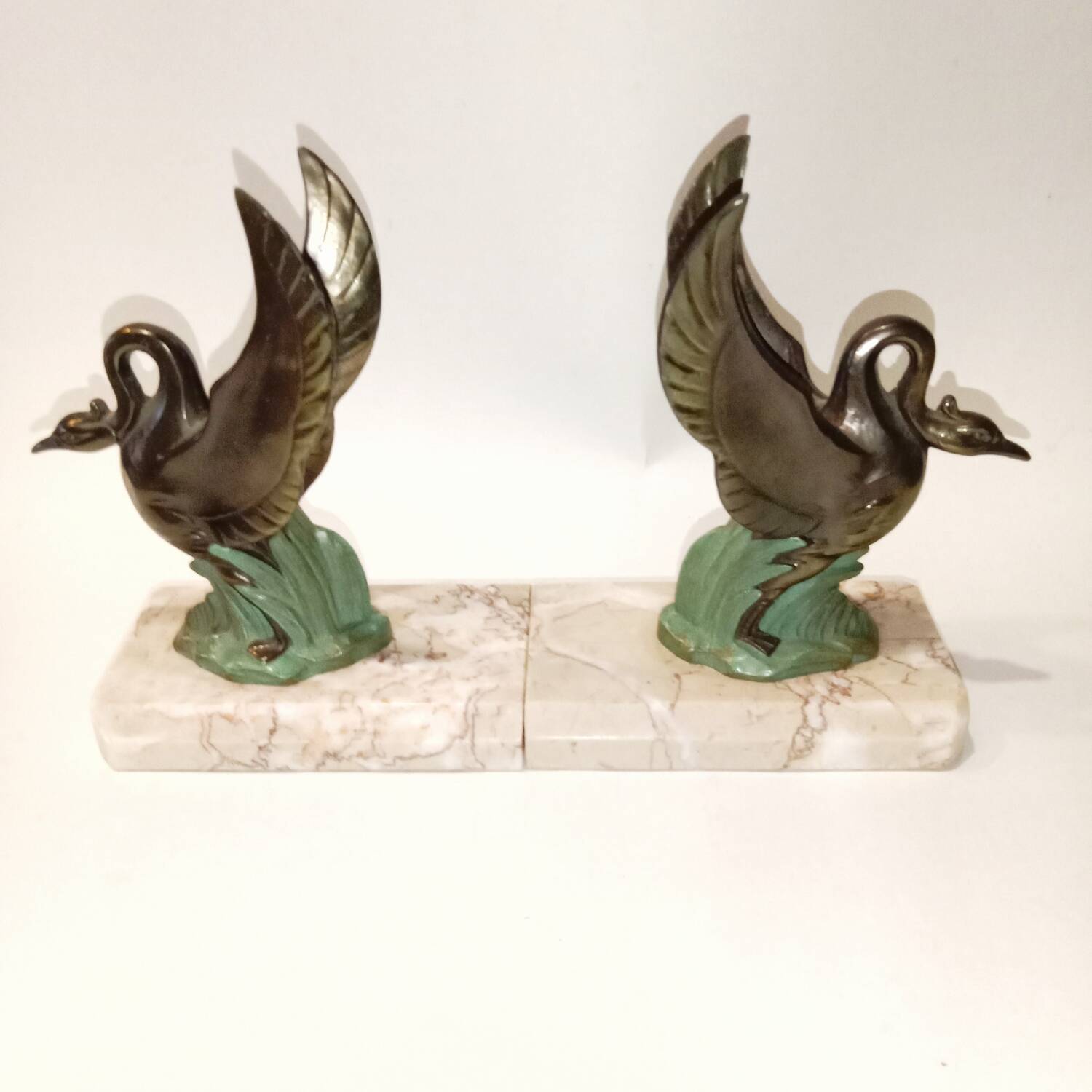 Art Deco bookends with metal swans, double patina and marble base.