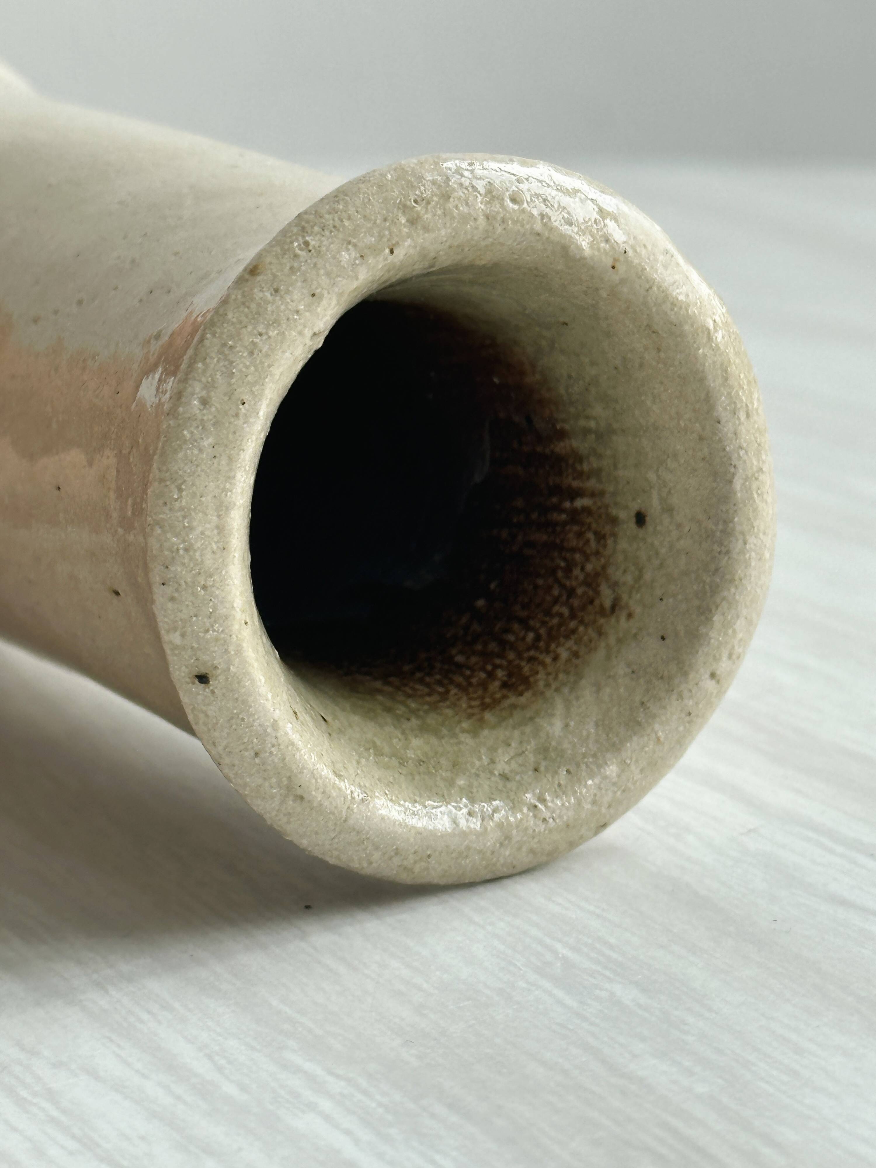 Minimalist beige ceramic vase.