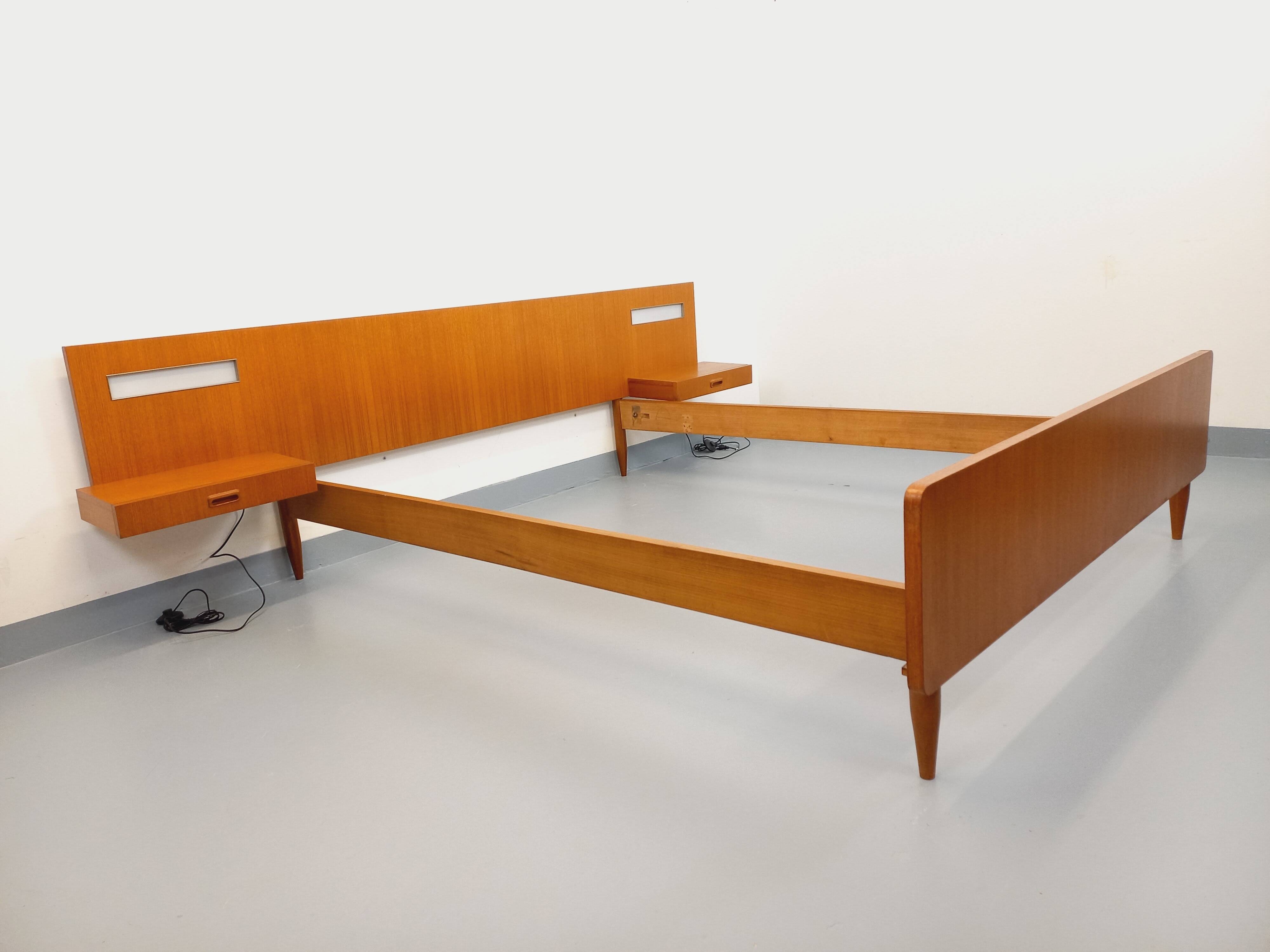 Double bed in vintage Scandinavian style from the 1960s with bedside tables.