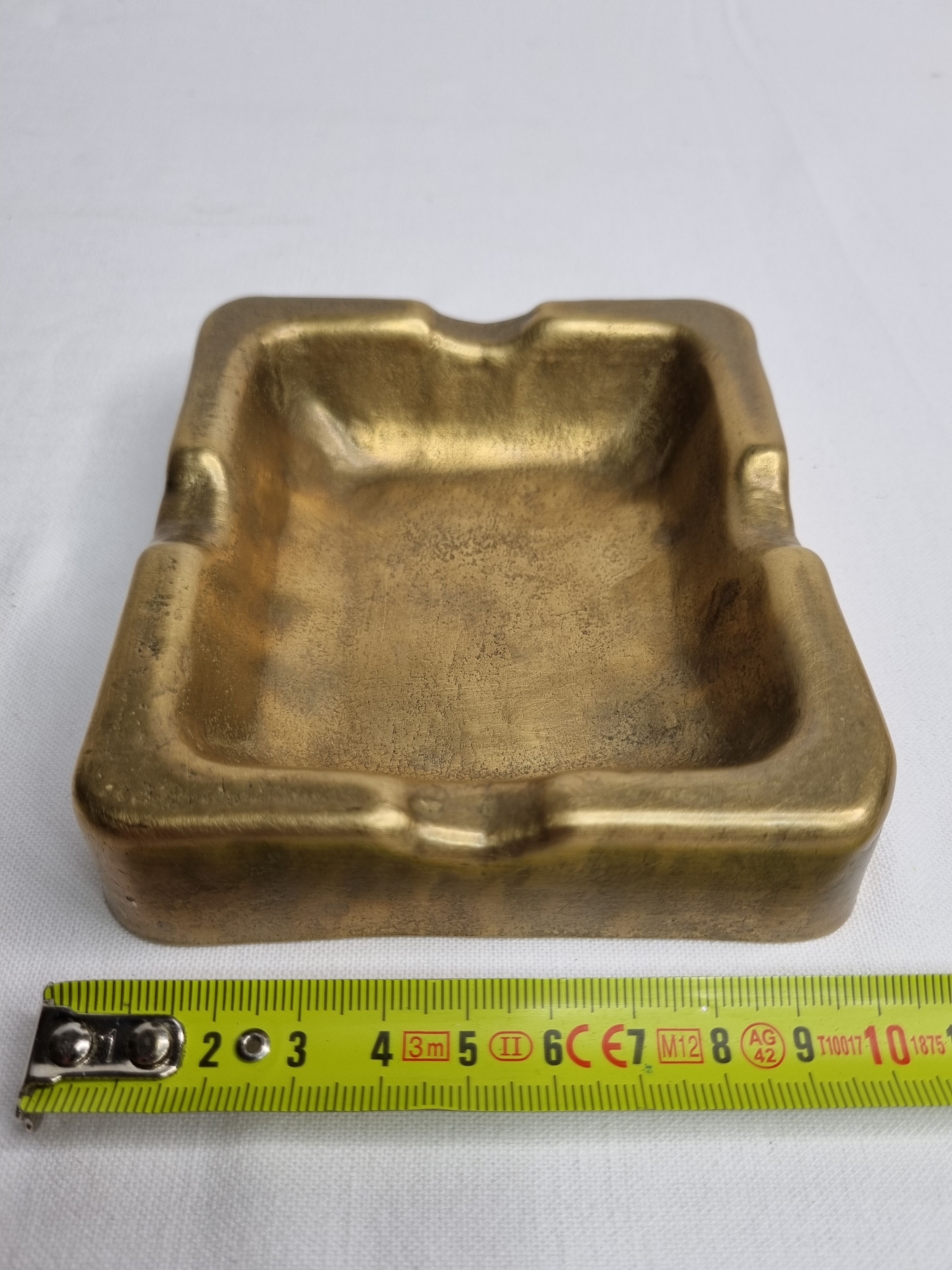 Empty pocket brutalist-inspired ashtray in gilded bronze