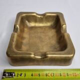Empty pocket brutalist-inspired ashtray in gilded bronze