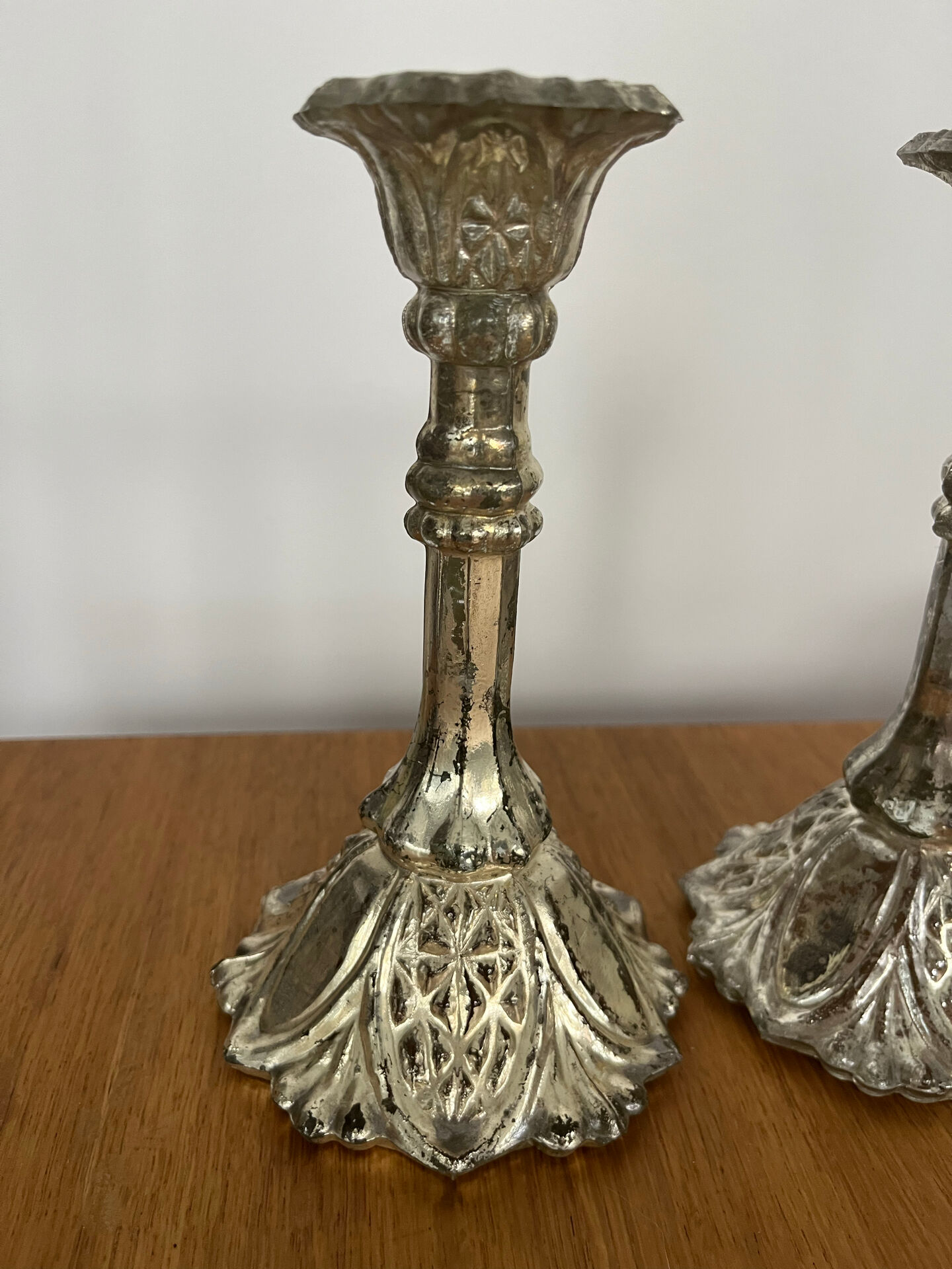 Pair of pressed glass candlesticks with silver plating.
