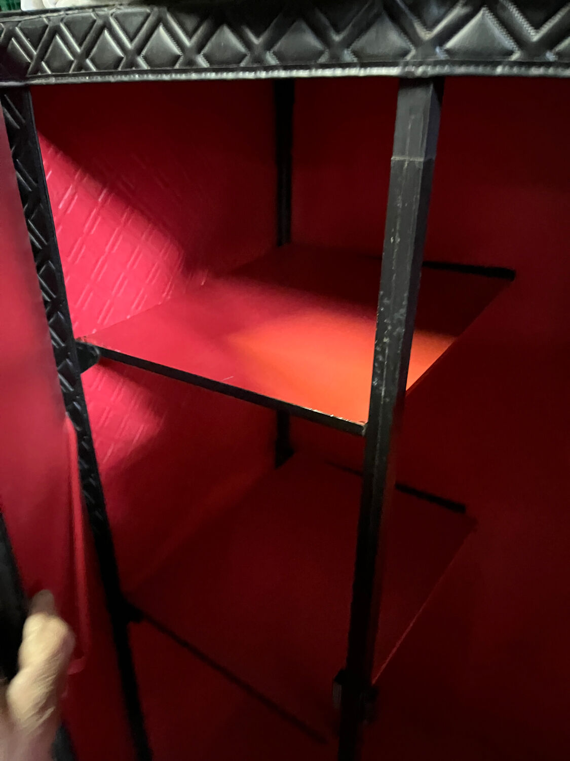 Contemporary wardrobe in black faux leather with diamond pattern and gold handles.