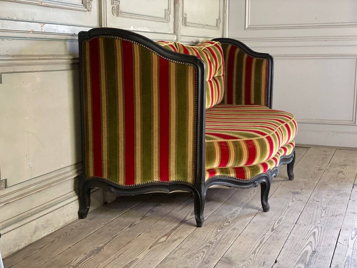 Louis XV style sofa in carved wood with a black patina