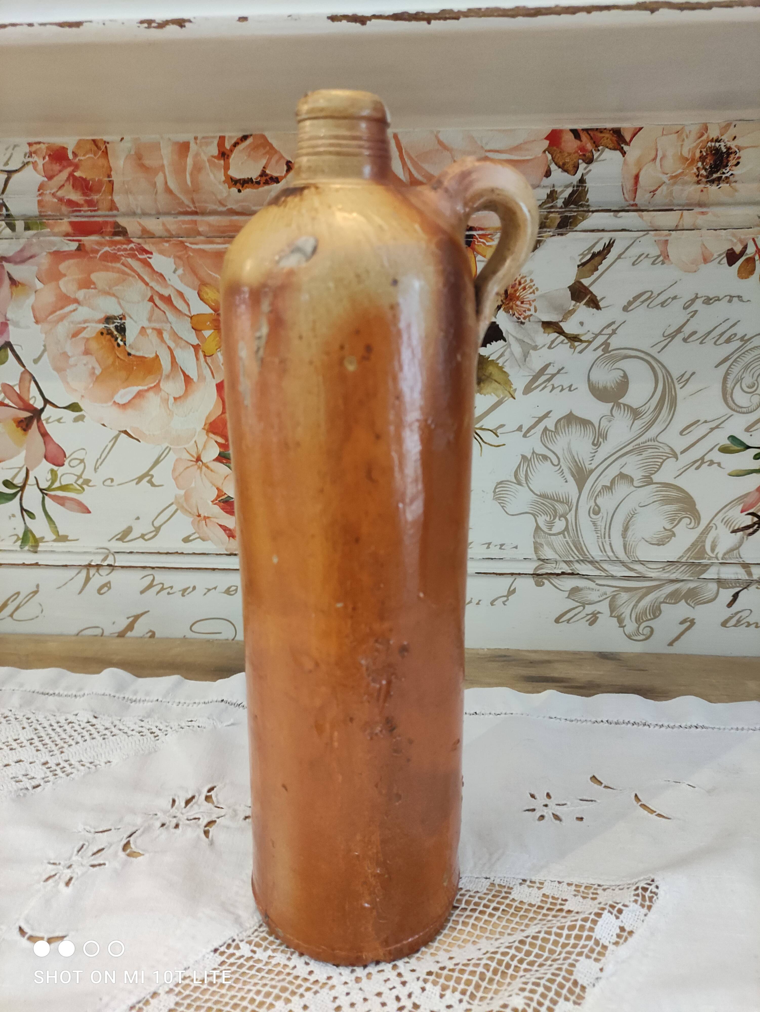 Old bottle in terracotta varnished finish