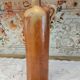 Old bottle in terracotta varnished finish