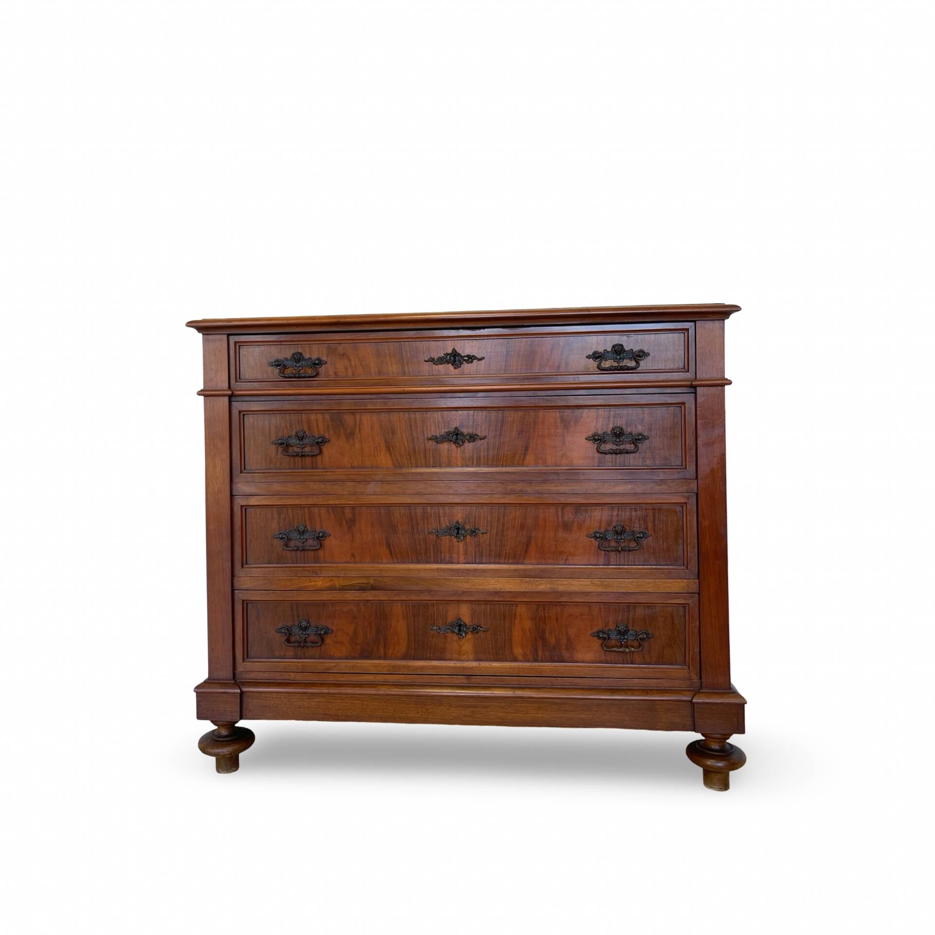 Antique walnut commode with bronze handles in the shape of a lion's mask,