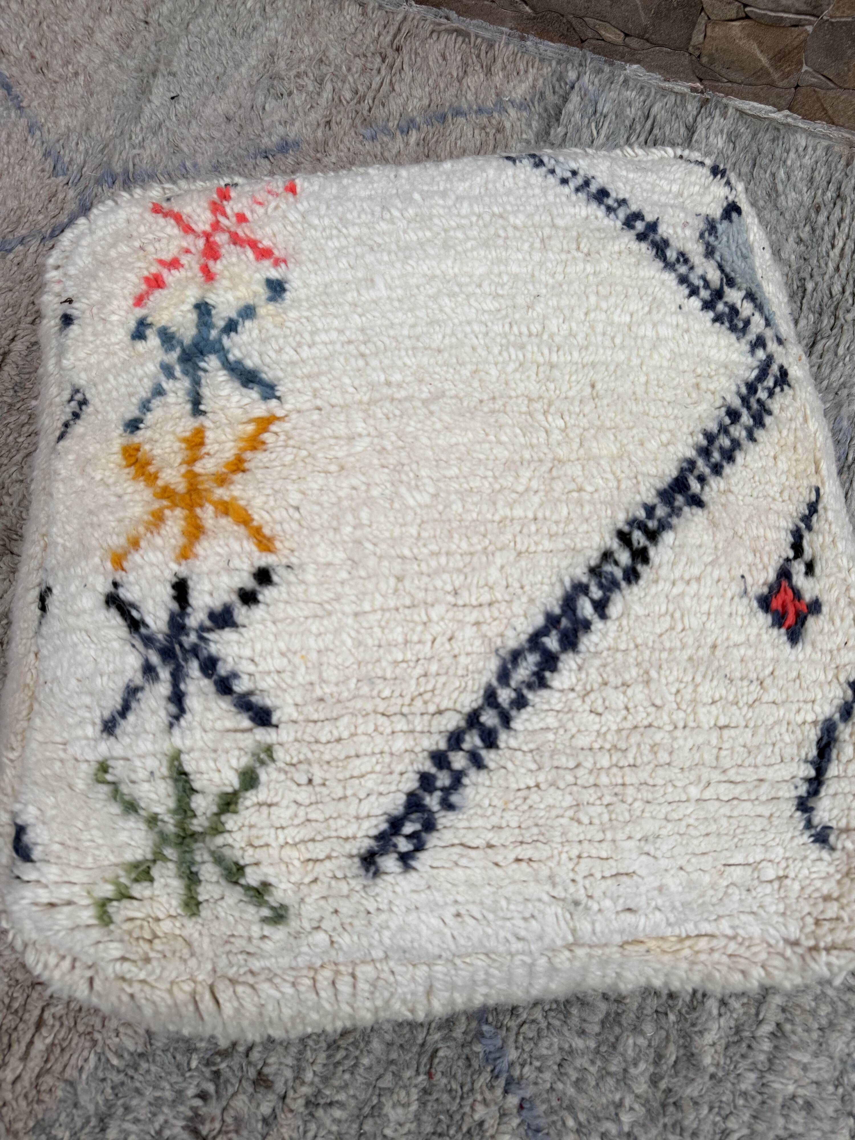Berber floor pouf: Handwoven Moroccan wool cushion.