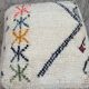 Berber floor pouf: Handwoven Moroccan wool cushion.
