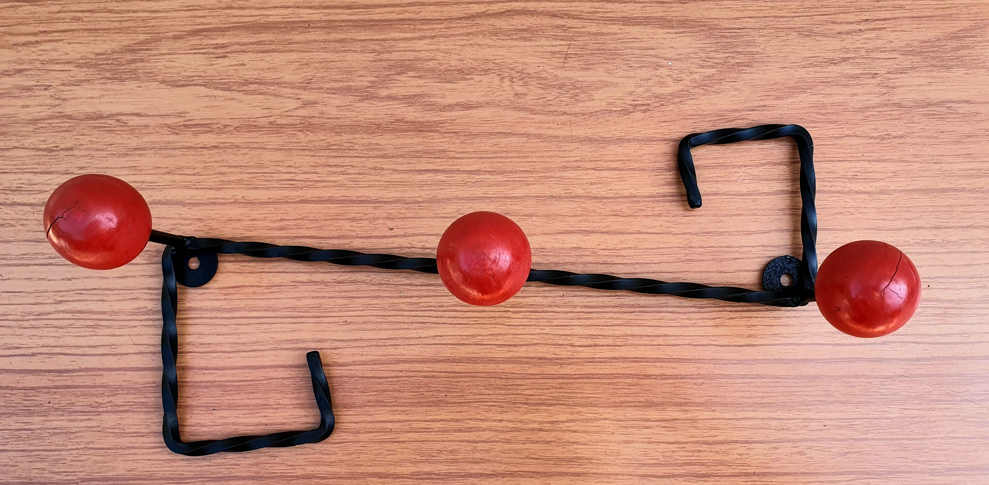 Coat rack wrought iron and red wooden balls