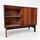 Low sideboard in rosewood with sliding doors. Denmark, 1960s