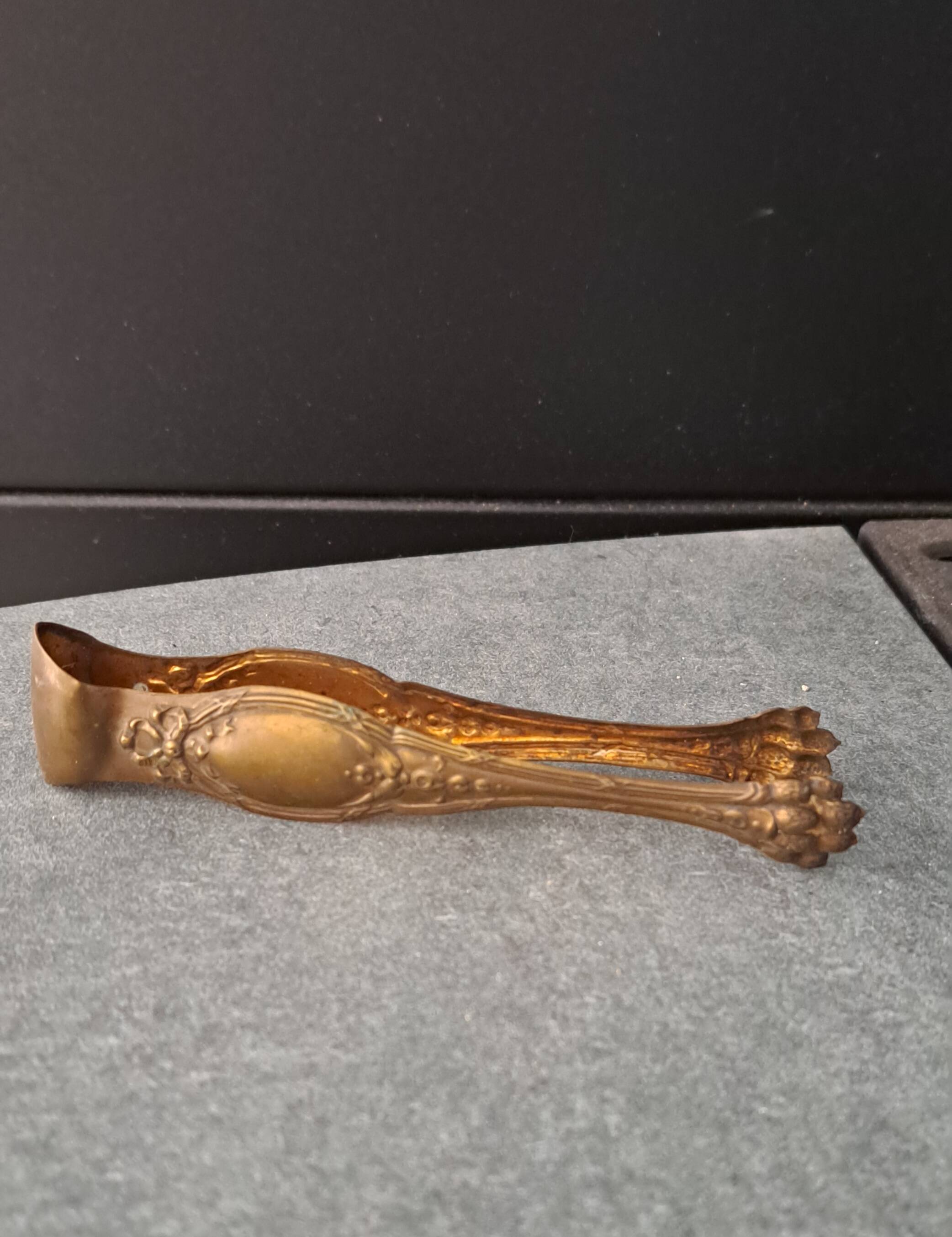 Antique sugar tongs with a system - Lion claws and Louis XV bow decoration.