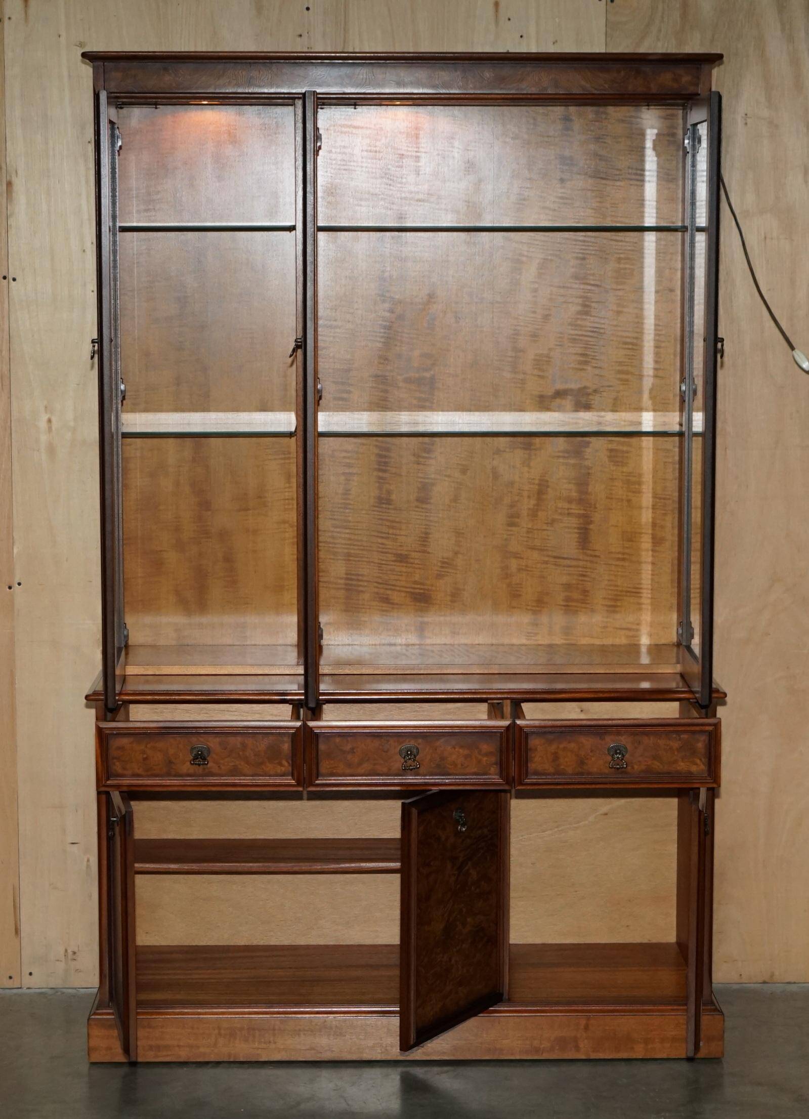 Vintage walnut burr buffet with glass and lighting, Art Deco style.