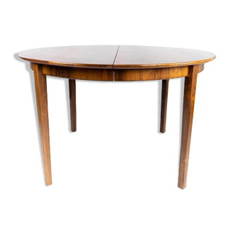 Dining table in rosewood with three extension plates, of danish design from the 1960s.