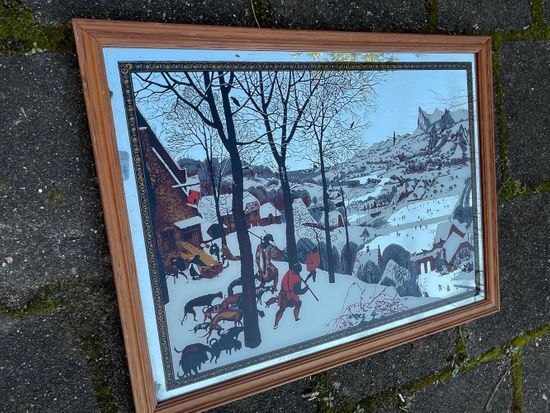 Vintage mirror painted hunters in the snow after painting by Pieter Bruegel the Elder (1565)