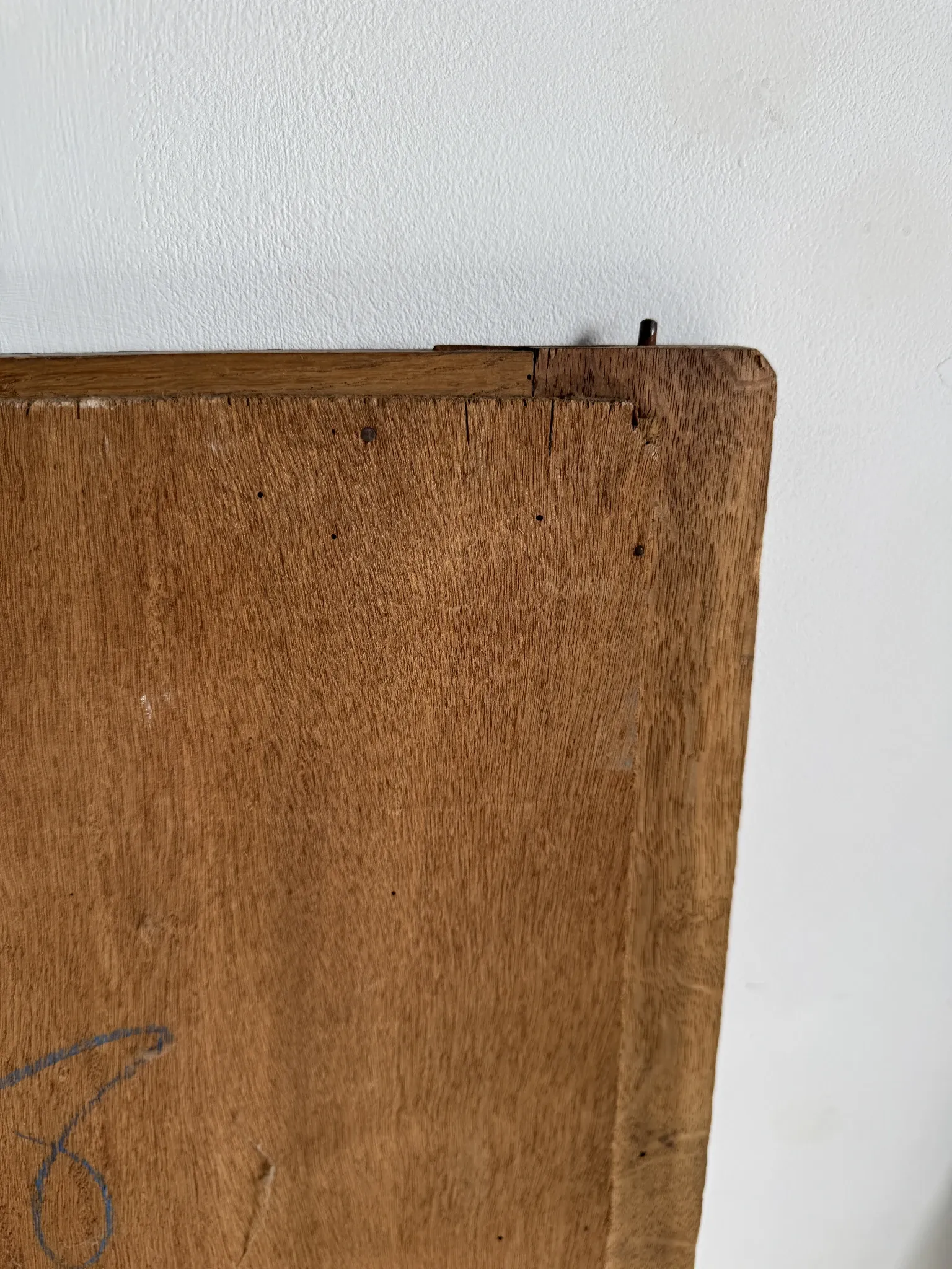 Antique mirror door (left) of a brown oak wardrobe with bevelled glass.