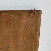 Antique mirror door (left) of a brown oak wardrobe with bevelled glass.