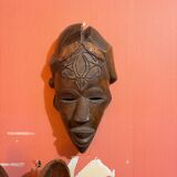 Tall carved mask with motifs